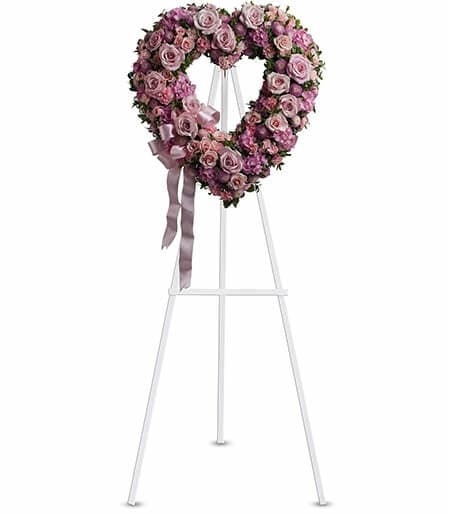 Heart-shaped floral tribute and cross arrangement